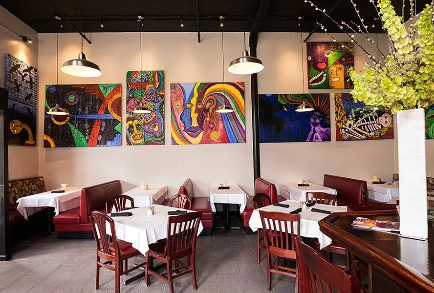 Cocina Latina’s dining area features bright paintings. - MABEL SUEN