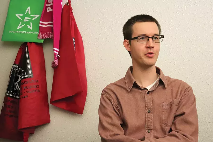 Life in the capitol is a grind for legislative aide Adam Speak, but he thinks the work is important. - JAMES POLLARD