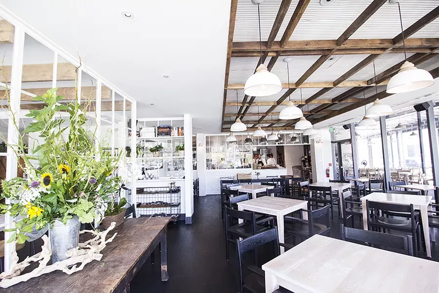 Vicia's striking dining room has a warmth despite its black and white color scheme. - MABEL SUEN