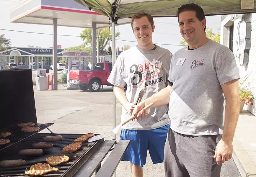 Pitmasters Tyler Barnes and Brian Montan work their magic. - MABEL SUEN