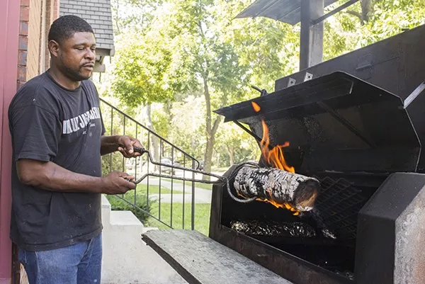 Antonio Ellis smokes meat outside 5 Aces BBQ. - MABEL SUEN