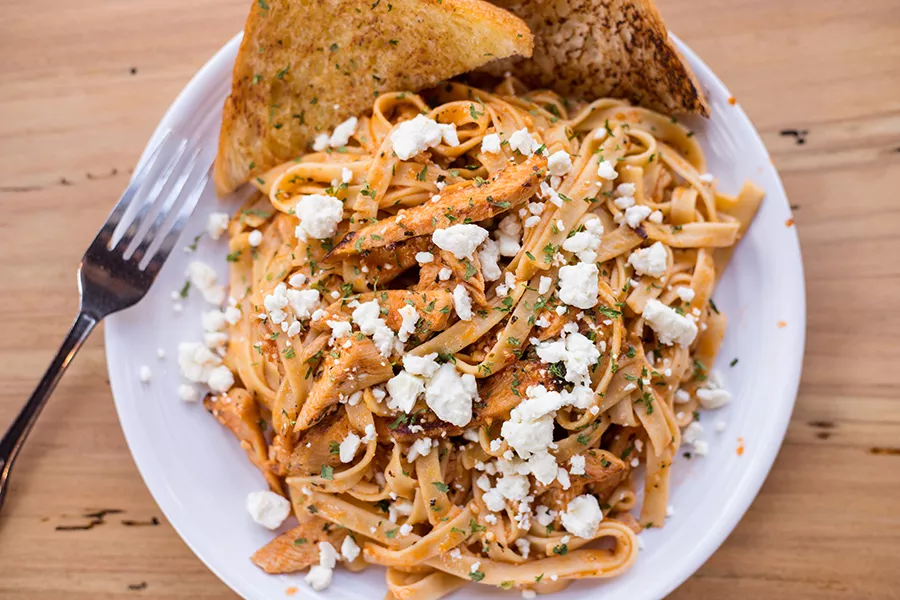 The chicken pasta is topped with tomato sauce, feta and Italian herbs. - MABEL SUEN