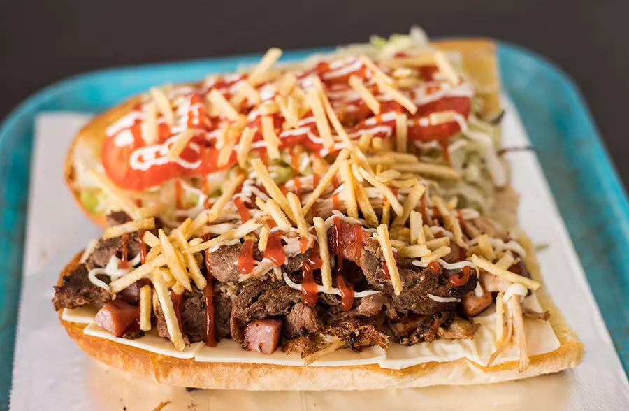 "La Tripleta" sandwich combines steak, pork and ham on toasted Cuban bread. - MABEL SUEN