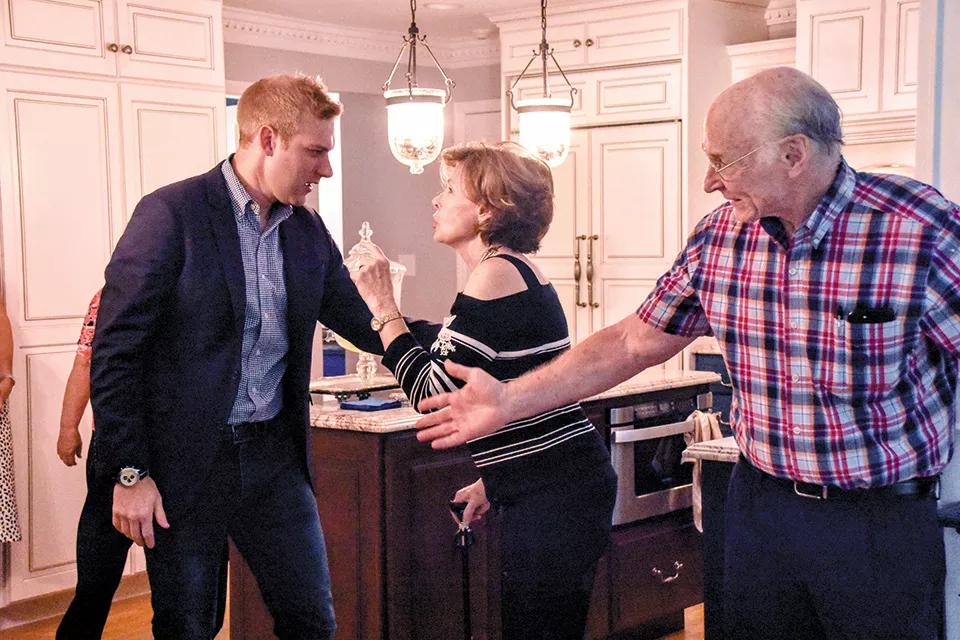 VanOstran talks with Democratic boosters Anne and John Bedwinek during an event at their home in Kirkwood. - DOYLE MURPHY