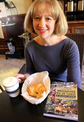 Amanda Doyle with a croissant and cappuccino from Rue Lafayette, a destination in her guidebook. - MABEL SUEN