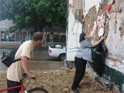 Shirley Wallace tears down a Cherokee art installation (to the displeasure of local artist Patrick Ritchey, on bike) in 2007 - PHOTO BY SHANNON KNOX