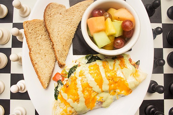 Spinach, tomato, cheddar and red onion omelet with fruit and toast. - MABEL SUEN
