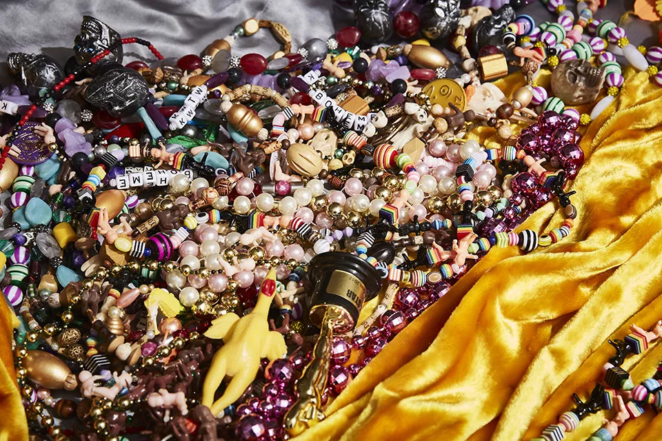 Auntie M's beads come from all over the world. Many are purchased, but some are acquired by barter. "I had to sweeten the deal a bit to make that trade," Auntie M says of his prized rubber chicken beads. - THEO WELLING