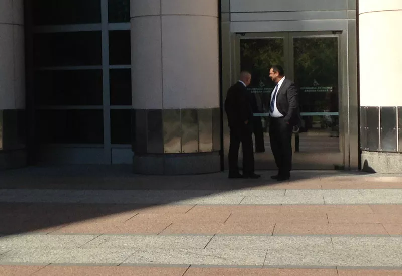 Steven Blakeney (left) speaks with longtime friend Lawrence Fleming on October 5 outside of the federal courthouse in St. Louis. - PHOTO BY DOYLE MURPHY