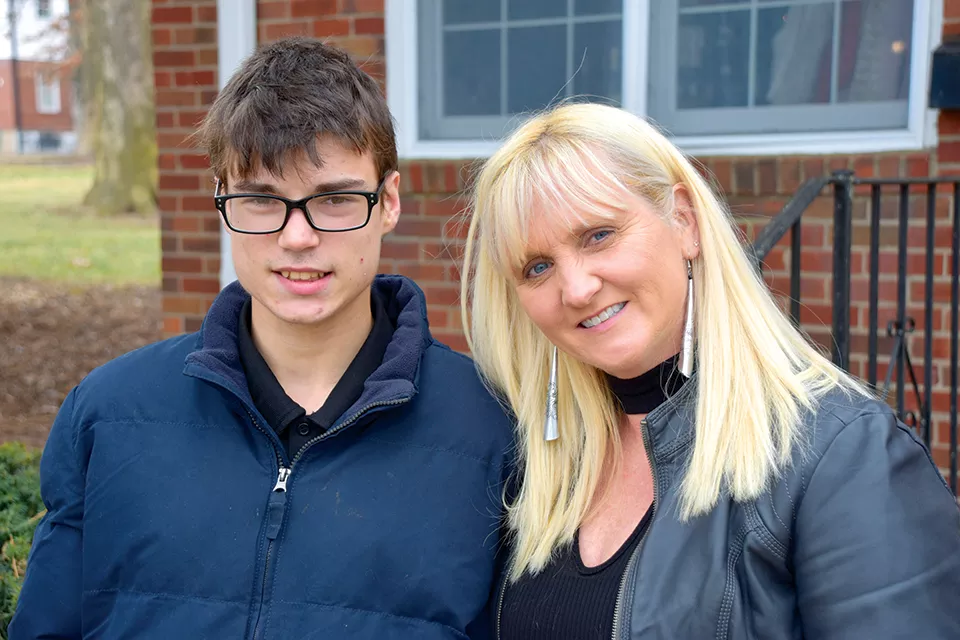 Austin and his mother, Laurie Calzada, outside their home in Brentwood. - DOYLE MURPHY