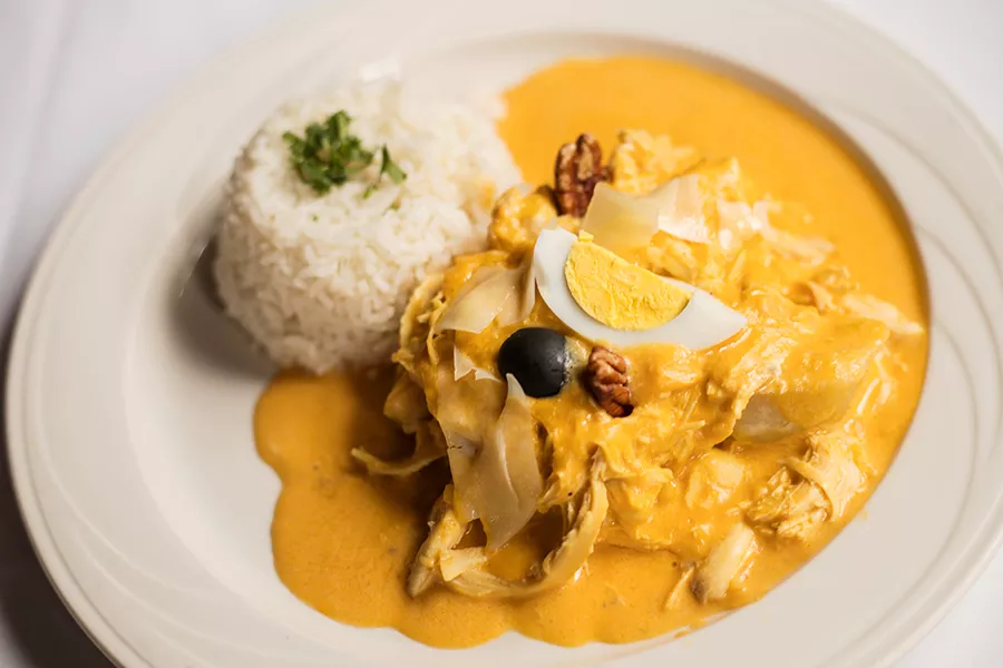Aji de gallina: shredded chicken, spicy aji Amarillo creamy sauce, potato, rice, boiled egg and olive. - MABEL SUEN