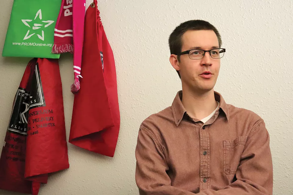 Life in the capitol is a grind for legislative aide Adam Speak, but he thinks the work is important. - JAMES POLLARD