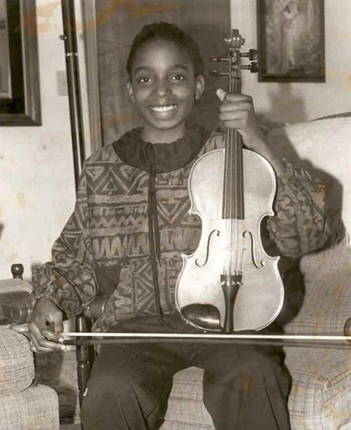 Conaway with her violin after winning a bronze medal at a state music competition at the age of 10. - COURTESY SYRHEA CONAWAY