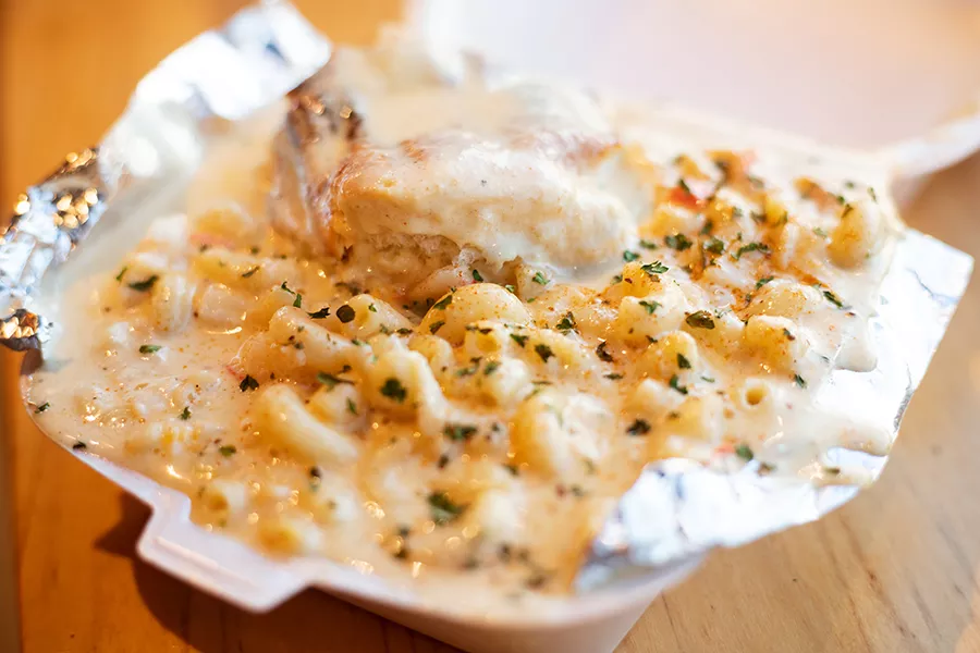 The signature Seafood Mac is made with a six-cheese blend, garlic, crab meat and pieces of garlic shrimp and served with a roll. - MABEL SUEN