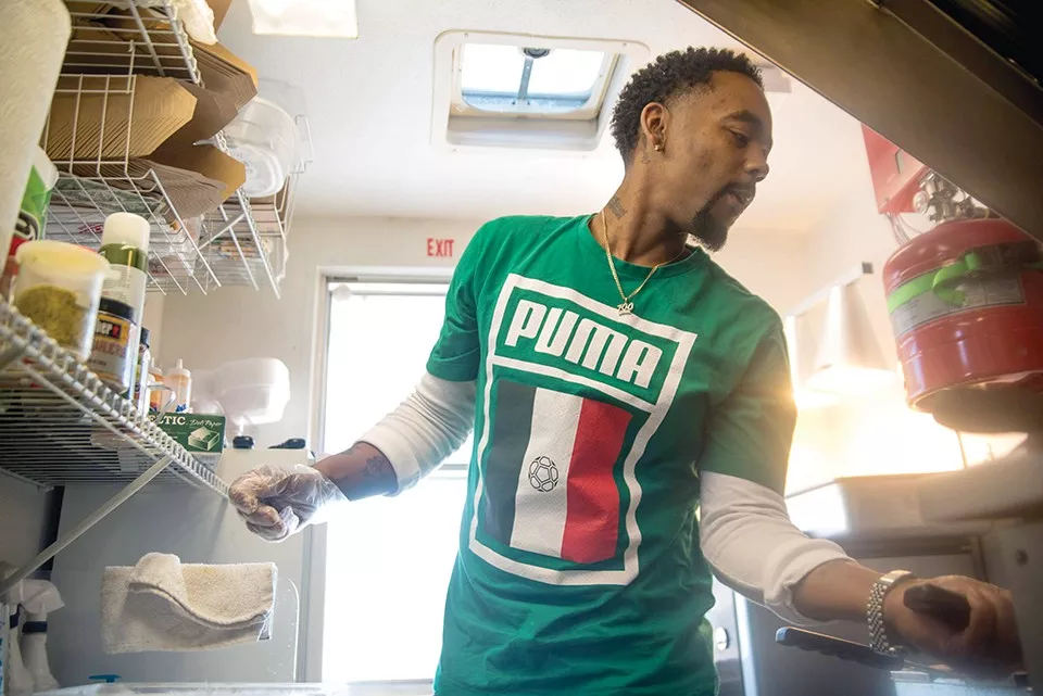 Dimetrious Woods works in his food truck in 2020 after his "erroneous" release from prison. - TRENTON ALMGREN-DAVIS
