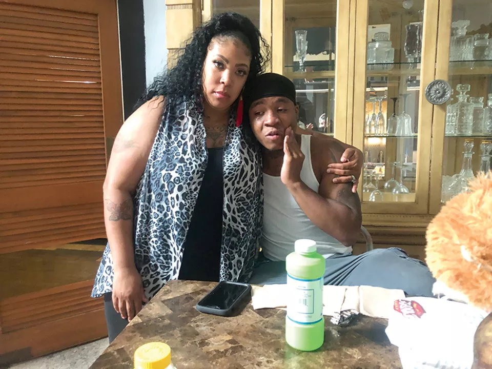 Nunu’s mother Trina Houshmand and older brother Donald lean on each other after the murder. - JOHN H. TUCKER