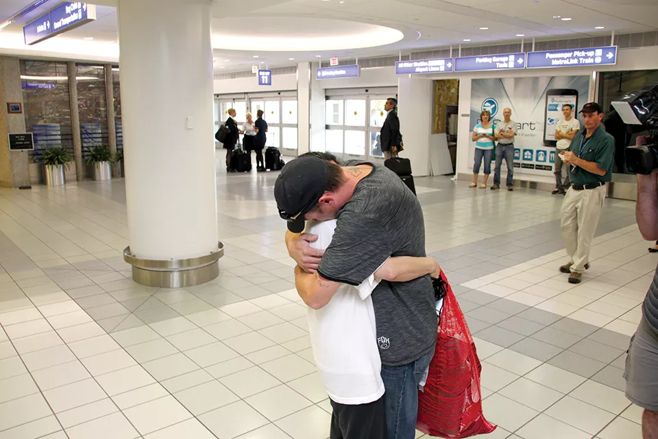 Separated for more than five months, Dow and Justin embrace in Lambert airport, reunited thanks to a last-minute reversal of her deportation. - RENEE BRONAUGH/PARK HILLS DAILY JOURNAL