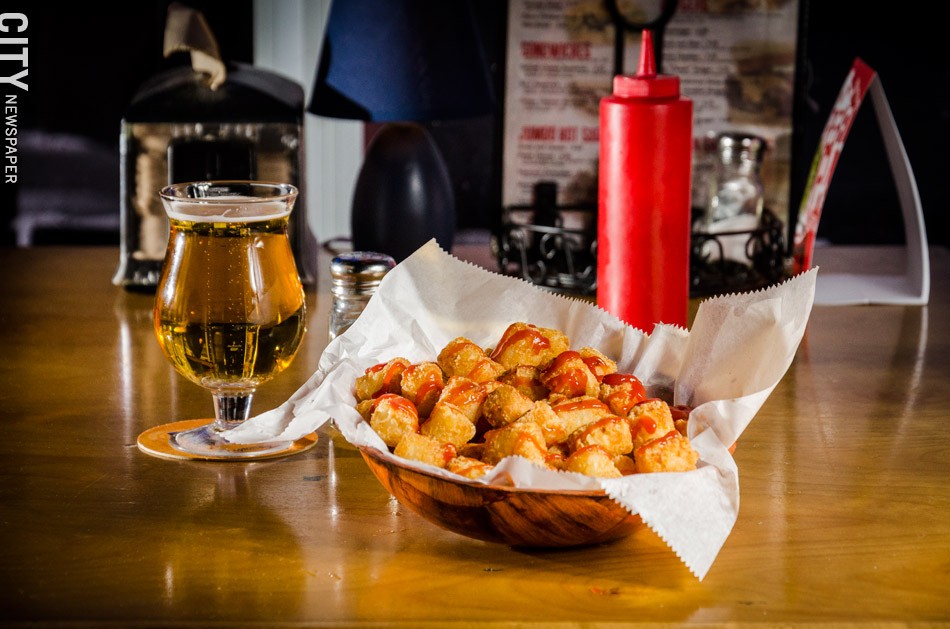 A basket of tater tots with a PBR from Acme Bar and Pizza. - PHOTO BY MARK CHAMBERLIN