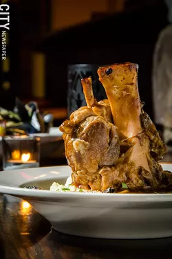 A braised pork shank with garlic-green-onion mash from Fraiche Bistro. - PHOTO BY MARK CHAMBERLIN