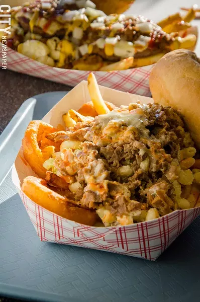 A Philly Plate from Mac's. Traditionally served with steak OR chicken, the one pictured includes both steak and chicken, cheese, mac salad, onion rings, french fries, hot sauce and served with an Amoroso roll. - PHOTO BY MARK CHAMBERLIN
