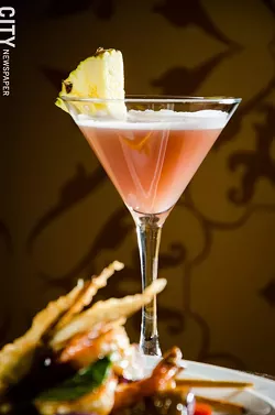 A Vietnamese Kiss cocktail made with mango vodka, pineapple juice, Chambord and champagne at Papaya. - PHOTO BY MARK CHAMBERLIN