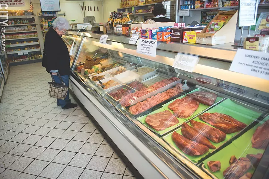 A woman surveys the display case at Lipman's Kosher Market. - PHOTO BY THOMAS DOOLEY
