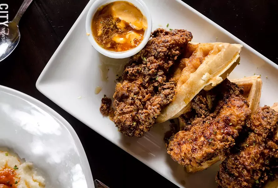 Belgian waffles with maple syrup, fried chicken, and smoked chili butter. - PHOTO BY MARK CHAMBERLIN