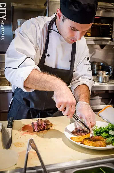 Chef Joel Valenti plating the Amore Steak. - PHOTO BY MARK CHAMBERLIN
