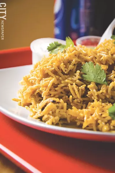 Chicken Biryani with rice cooked with heavy cream, cilantro, nuts, and raisins. - PHOTO BY MARK CHAMBERLIN