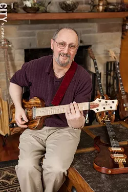Greg Bogoshian with one of his guitars - PHOTO BY JOHN SCHLIA