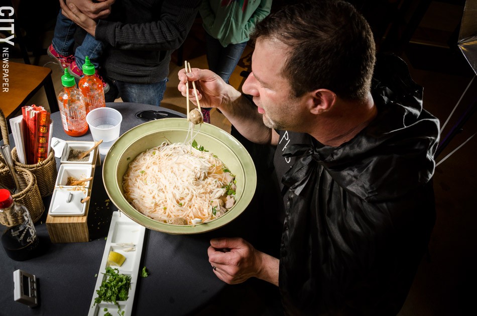 Greg Davis attempts to eat a seven-pound bowl of Pho at The Soup Spoon in Victor. - PHOTO BY MARK CHAMBERLIN