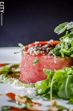 Grilled watermelon salad with arugula, feta cheese, hazelnuts, avocado and cucumber vinaigrette from Avvino. - PHOTO BY MARK CHAMBERLIN