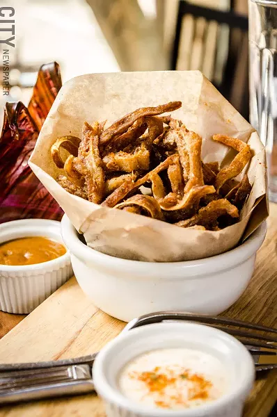 Ox and Stone incorporates flavors from Spain and Latin influences, which can be seen in the crispy pig ears with blackstrap rum bbq sauce and mojo aioli. - PHOTO BY MARK CHAMBERLIN