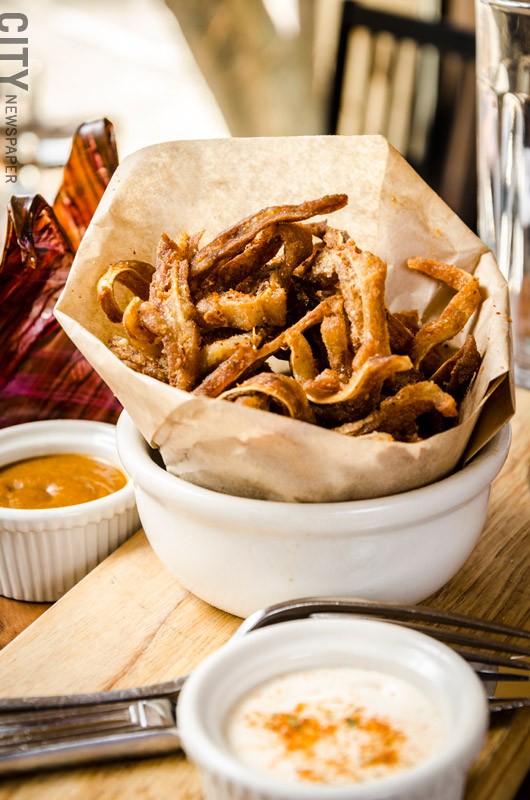 Ox and Stone incorporates flavors from Spain and Latin influences, which can be seen in the crispy pig ears with blackstrap rum bbq sauce and mojo aioli. - PHOTO BY MARK CHAMBERLIN