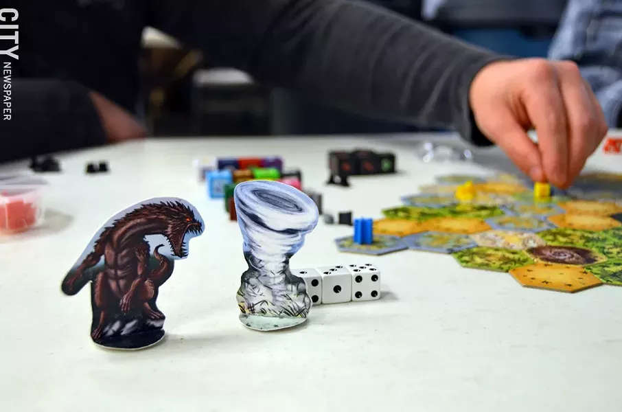 Pawns, dice and tiles from the locally-created game Island Dice. - PHOTO BY MATT DETURCK