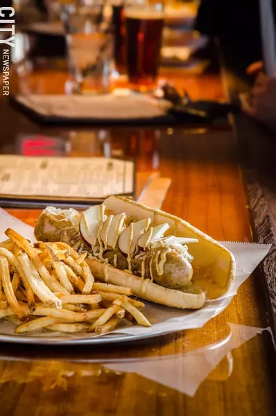 Pork sausage with caramelized onions, swiss cheese, apples, and spicy mustard from Rochester Taproom. - PHOTO BY MARK CHAMBERLIN