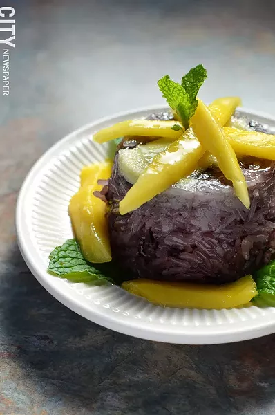 Purple rice dessert with sweet custard and mango. - PHOTO BY MATT DETURCK