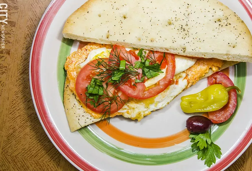 Rochester has an abundance of breakfast sandwich options, ranging form the standard to the more creative, like Voula's: Breakfast Sandwich with two fried eggs, kafteri, and fresh herbs on lagana flatbread. - PHOTO BY MARK CHAMBERLIN