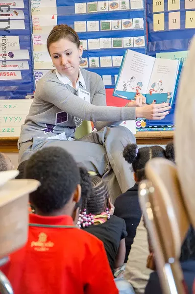 Rochester Young Professionals member Pamela Smith reads to kids as part of a volunteer activity. - PHOTO BY MARK CHAMBERLIN