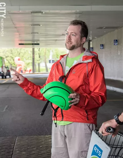 Jesse Peers, a certified cycling instructor, gives direction to a group of cyclists before departing for a group ride. - PHOTO BY JACOB WALSH