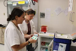 Kristen Wagner, left, and Chelsea Bailey, of the Yates County public health department, log the vaccines they administered in the homes of Mennonite families Tuesday. - PHOTO BY BRETT DAHLBERG