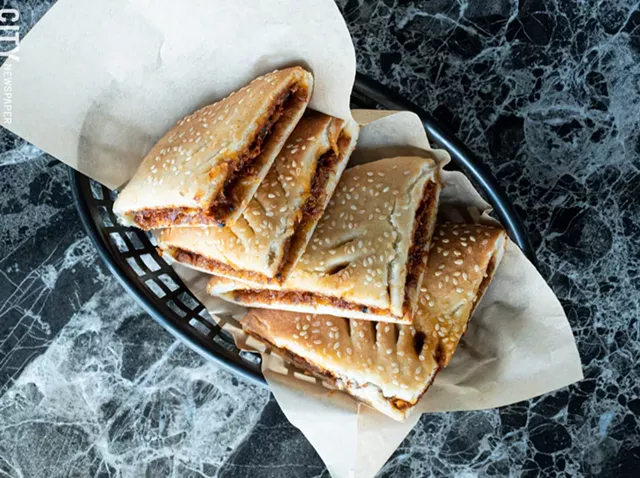 An order of Syrian manakeesh at Levantine's comes in two savory varieties: one turnover is filled with spinach and onions, and the other stuffed with a smoky red pepper and tomato paste. - PHOTO BY JACOB WALSH