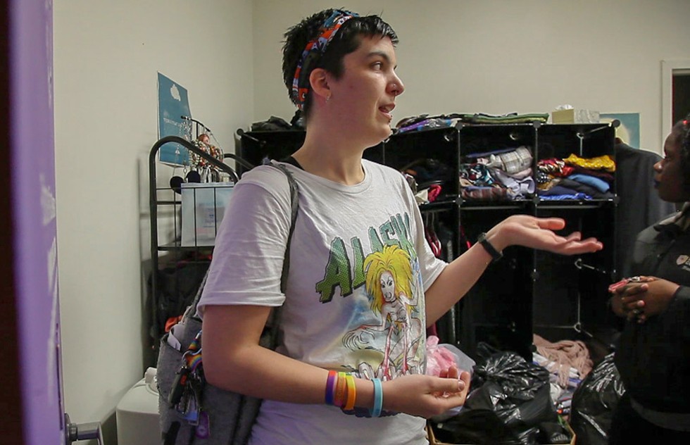 Jess Whitehouse, 30, stands in the community closet at Positive Force Movement. Whitehouse, whose pronoun is “they,” says clothes shopping can be a harrowing experience for trans people, but the closet offers support and builds community. - PHOTO BY MAX SCHULTE