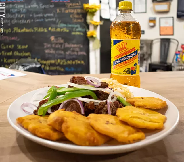 Griyo (fried pork), fried plantains, and picklin (fermented cabbage). - PHOTO BY JACOB WALSH