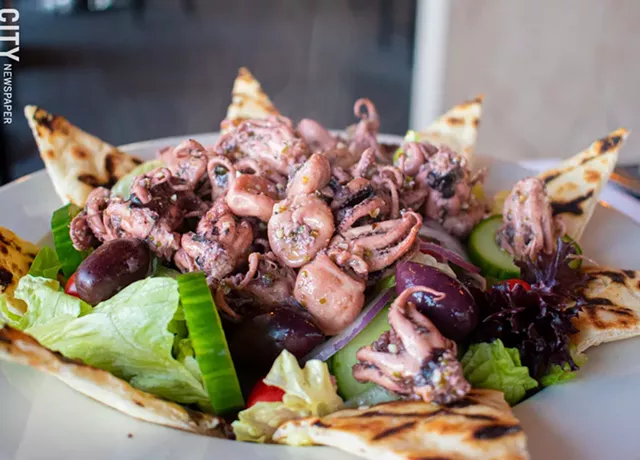 The refreshing octopus salad is tossed with cucumber, tomato, red onion, parsley, chili peppers, and house-made Greek dressing, served on a bed of shredded fennel. - PHOTO BY JACOB WALSH