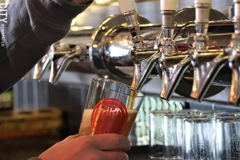 Three Heads' David Coniglio pouring a fresh glass of the brewery's Lancer Lager. - PHOTO BY GINO FANELLI