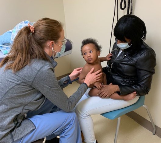 Lakeyshia Williams, right, holds her 8-month-old son, Dareem, as nurse practitioner Jamie Miller examines him. - PHOTO PROVIDED BY URMC