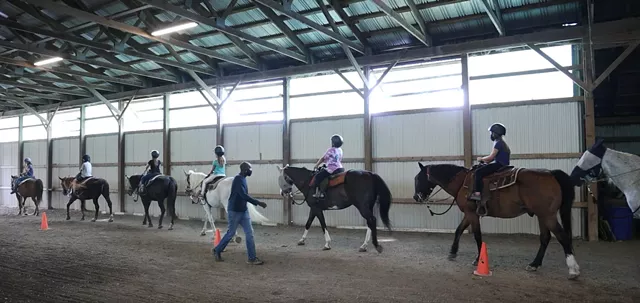 The program at A Horse's Friend teaches feeding, maintenance — and, of course, riding the gentle beasts. - PHOTO CREDIT MAX SCHULTE / WXXI NEWS