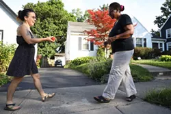 Lindsey Downey brings a peach to her neighbor, Janet Williams. - PHOTO BY MAX SCHULTE