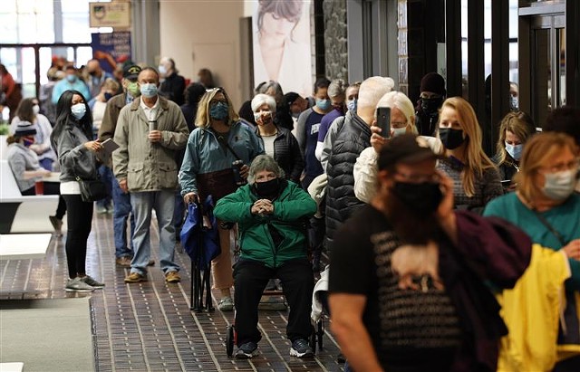 Voters waited in long lines at Perinton Square Mall over the weekend to cast their ballots early. Sunday, Oct. 25, 2020. - PHOTO BY MAX SCHULTE